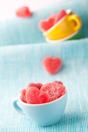 Heart shape candy in cups for Valentine's day on a light blue backgroundの写真素材