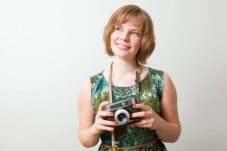 Young woman holding an old vintage cameraの写真素材