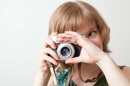 Young woman holding an old vintage camera