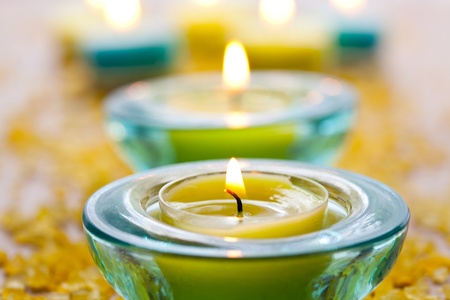 Close-up of blue and yellow candles with yellow bath saltの写真素材