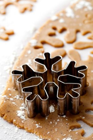 Making gingerbread cookies for Christmas. Gingerbread dough with snowflake shapes.の写真素材