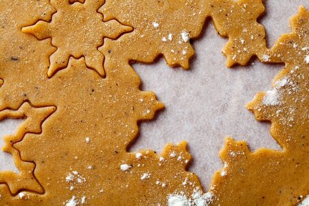 Making gingerbread cookies for Christmas. Gingerbread dough with star shapes.