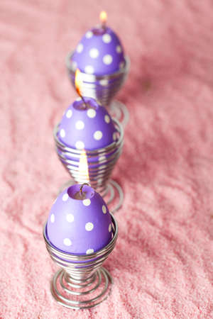 Close-up of purple dotted Easter egg candlesの写真素材