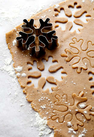 Making gingerbread cookies for Christmas. Gingerbread dough with snowflake shapes.の写真素材