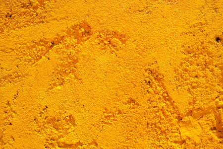 Bright yellow stone wall background texture from Assos, Kefalonia, Greece