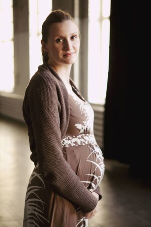 Portrait of pregnant mother. Natural portrait in an indoor location.