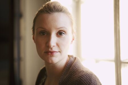 Portrait of a beautiful woman, looking serious. Natural portrait indoors.の写真素材