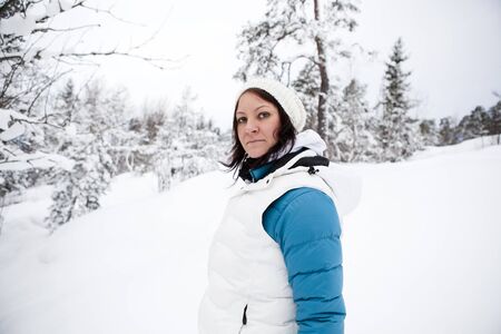 Portrait of a woman outdoors on a white winter dayの写真素材
