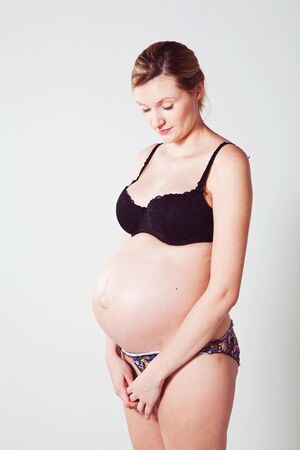 Portrait of a beautiful pregnant mother. Studio shot.の写真素材