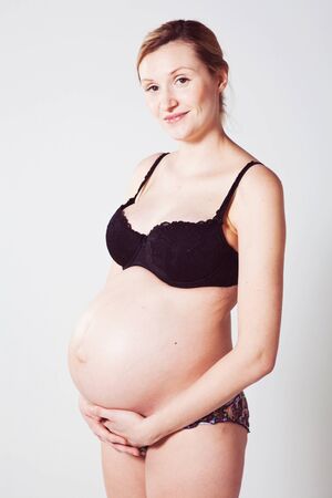 Portrait of a beautiful pregnant mother. Studio shot.の写真素材