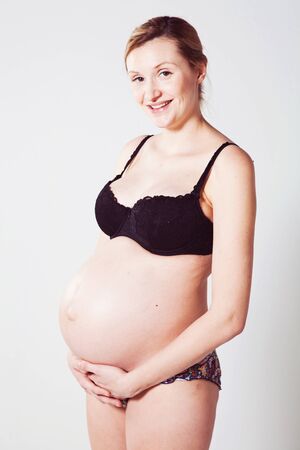 Portrait of a beautiful pregnant mother. Studio shot.の写真素材