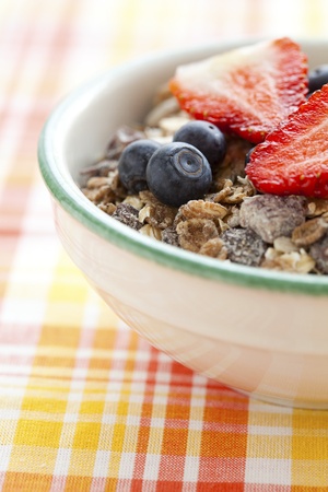 Bowl of muesli, strawberries and blueberries for healthy breakfastの写真素材