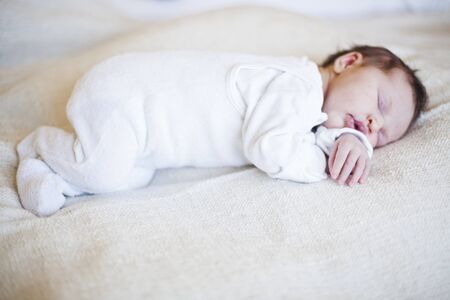 Portrait of a cute newborn baby girl sleepingの写真素材