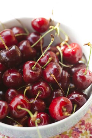 Close-up of fresh delicious and ripe cherries in a bowlの写真素材