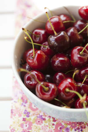 Close-up of fresh delicious and ripe cherries in a bowlの写真素材