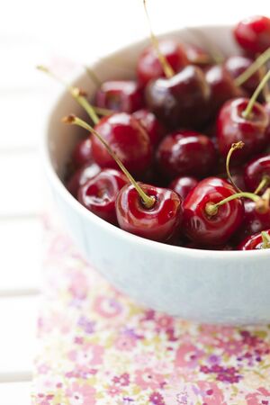 Close-up of fresh delicious and ripe cherries in a bowlの写真素材