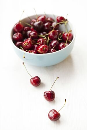 Close-up of fresh delicious and ripe cherries in a bowlの写真素材