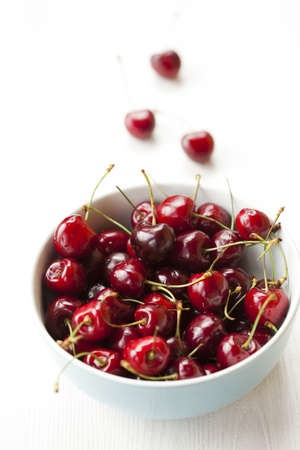 Close-up of fresh delicious and ripe cherries in a bowlの写真素材