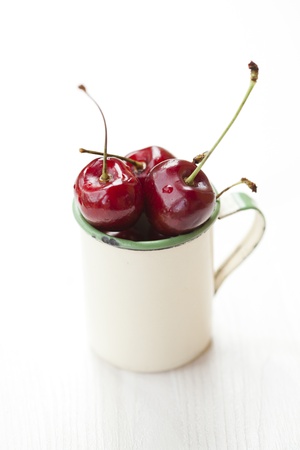 Close-up of fresh delicious and ripe cherries in a cupの写真素材