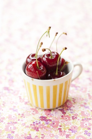 Close-up of fresh delicious and ripe cherries in a cup
