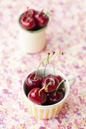 Close-up of two cups of fresh, delicious and ripe red cherriesの写真素材