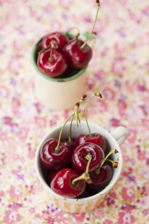 Close-up of two cups of fresh, delicious and ripe red cherriesの写真素材
