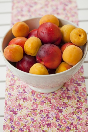 Close-up of a bowl with fresh and ripe apricots and nectarinesの写真素材
