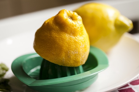 Close-up of fresh lemon, making lemon juice with squeezerの写真素材