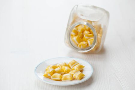 Close-up of hard yellow candy with white stripes.の写真素材