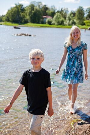 Mother and son on the beach on a beautiful summer dayの写真素材