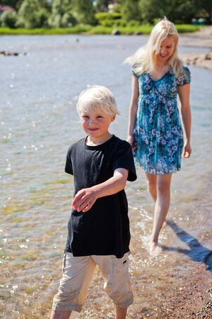 Mother and son on the beach on a beautiful summer dayの写真素材