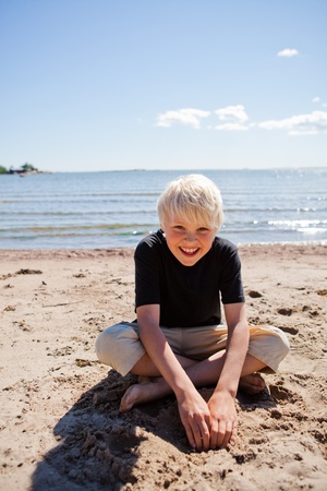 Boy on the beach on a beautiful sunny summer dayの写真素材