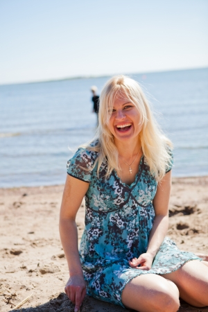 Beautiful woman sitting at the beach relaxingの写真素材