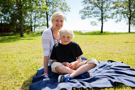 Portrait of a mother and son outdoors on a beautiful summer dayの写真素材