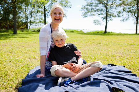 Portrait of a mother and son outdoors on a beautiful summer dayの写真素材