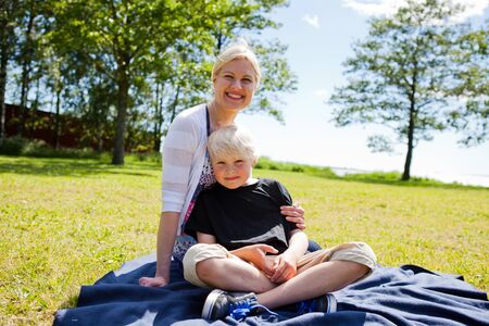 Portrait of a mother and son outdoors on a beautiful summer dayの写真素材