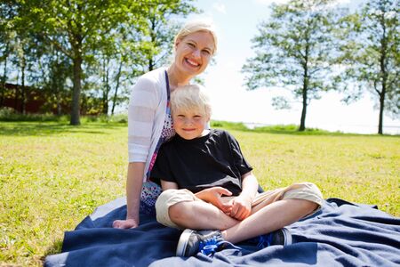 Portrait of a mother and son outdoors on a beautiful summer dayの写真素材