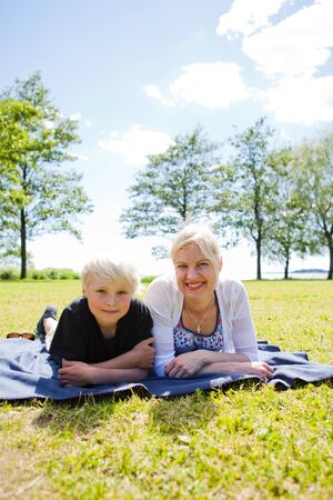 Portrait of a mother and son outdoors on a beautiful summer dayの写真素材