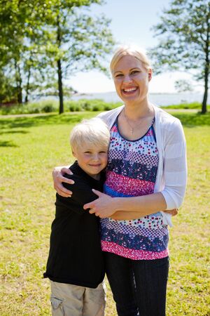Portrait of a mother and son outdoors on a beautiful summer dayの写真素材