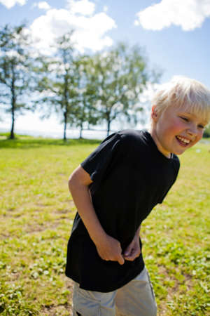 Portrait of a boy outdoors on a beautiful summer dayの写真素材