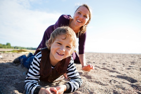 Mother and son relaxing and spending time together on the beach.の写真素材