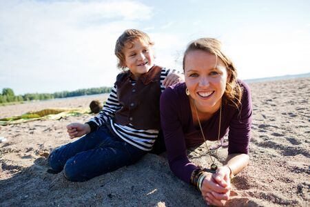 Mother and son relaxing and spending time together on the beach.の写真素材