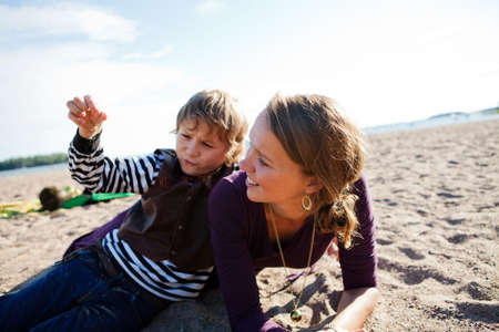Mother and son relaxing and spending time together on the beach.の写真素材