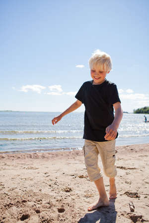 Boy on the beach on a beautiful sunny summer dayの写真素材
