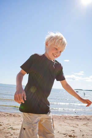 Boy on the beach on a beautiful sunny summer dayの写真素材