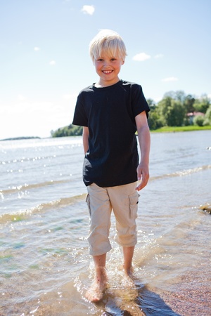 Boy on the beach on a beautiful sunny summer dayの写真素材