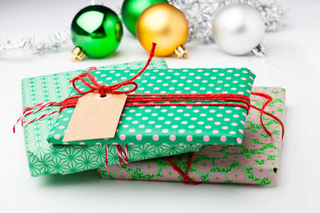 Wrapped Christmas gifts and bauble and silver glitter decorationsの写真素材