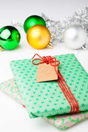 Wrapped Christmas gifts and bauble and silver glitter decorationsの写真素材