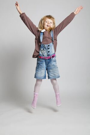 Studio portrait of happy young girl jumpingの写真素材