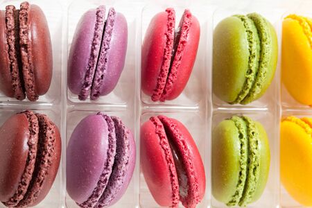 Close-up of assortment of colorful macaroons in tray on light backgroundの写真素材